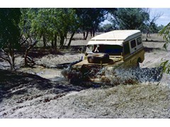 1974 : Traversing in western Queensland; Land Rover at creek crossing.