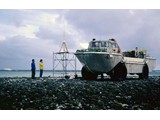 Bathymetric Survey, 9 April-12 May 1987 : At Elizabeth Reef sand cay with LARC alongside Magnavox with its receiving antenna on the scaffold over the ground mark; the MV Cape Pillar is in the far background; Peter Kaczerepa has blue jacket and Vicki the yellow.